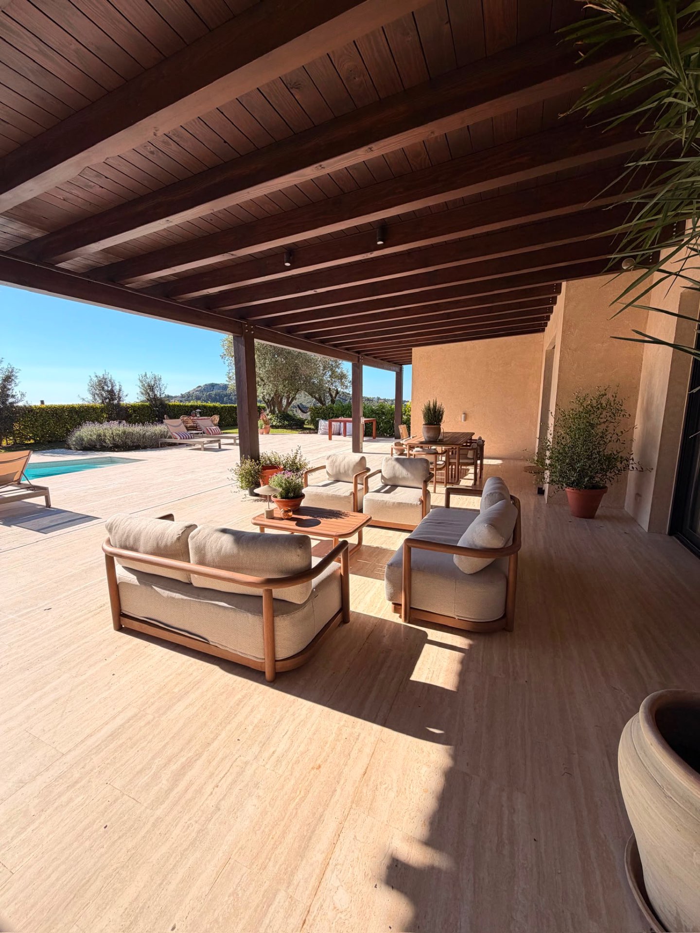 Loungeruimte onder pergola bij het zwembad